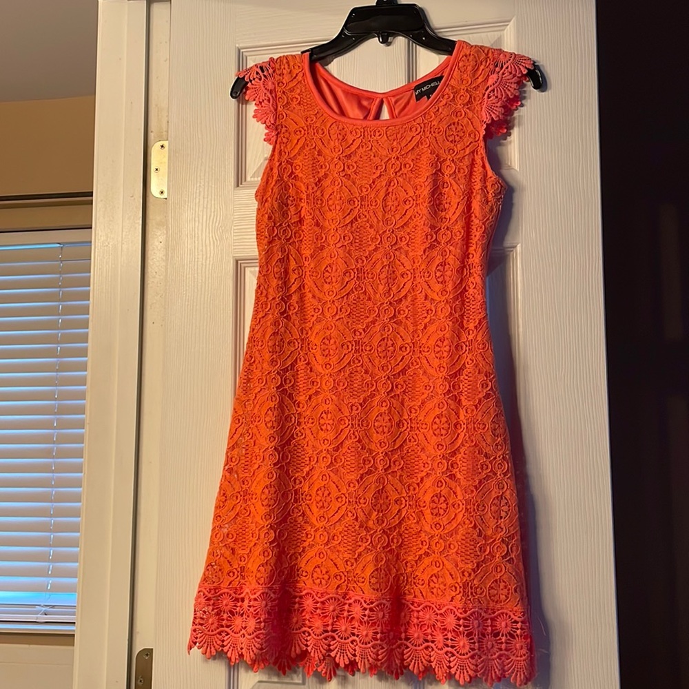 Beautiful lace covered mini dress. More of a coral color